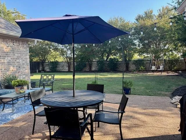 a front view of house with yard and outdoor seating