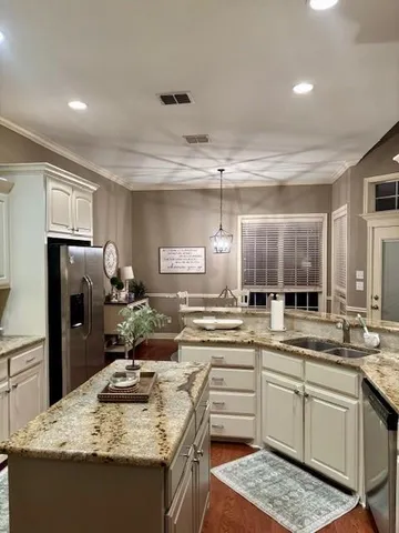 a kitchen with a sink stove and refrigerator