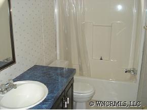 601 Parris Road Rutherfordton, NC 28139 - Photo 12 of 12 a bathroom with a granite countertop sink and a mirror
