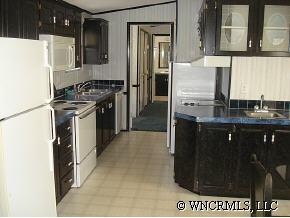 601 Parris Road Rutherfordton, NC 28139 - Photo 8 of 12 a kitchen with stainless steel appliances granite countertop a refrigerator a stove and a sink