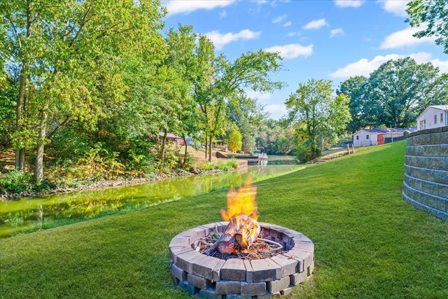 a view of yard with swimming pool and green space
