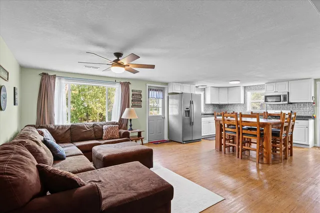 a view of a dining room with furniture and wooden floor