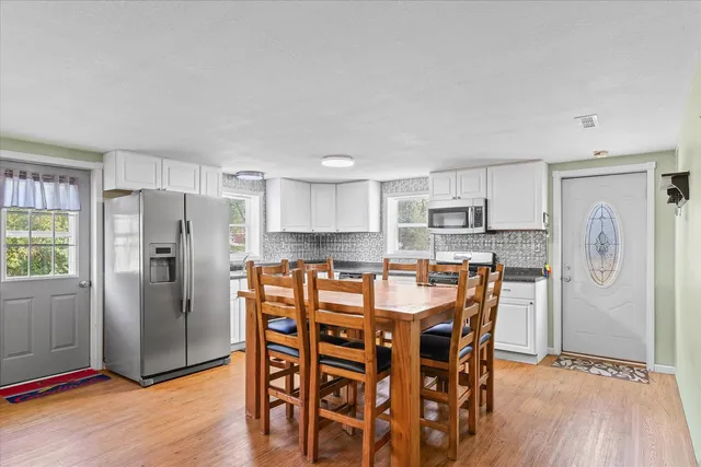 a kitchen with stainless steel appliances a refrigerator stove microwave and cabinets