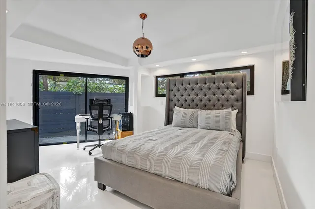 a bathroom with a bathtub and a flat screen tv