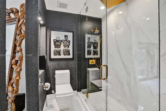 a bathroom with a toilet a sink and mirror