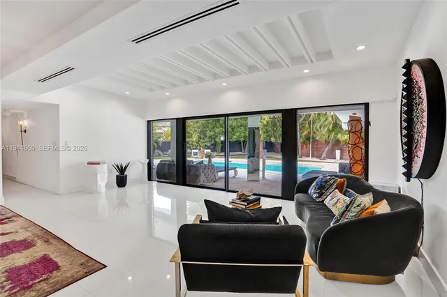 a view of a livingroom with furniture staircase and a large window