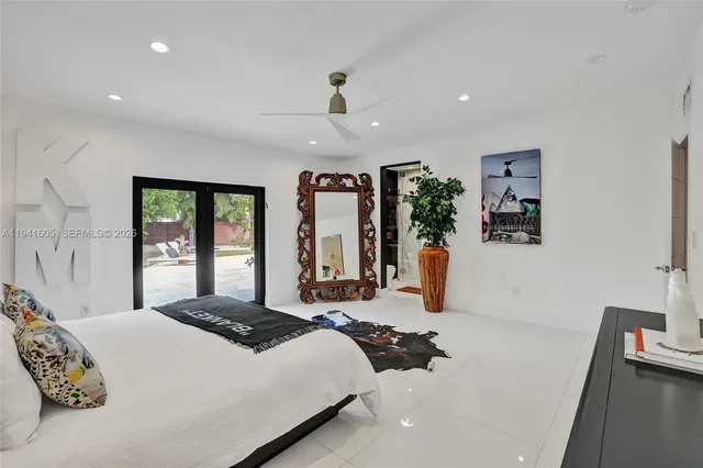 a view of a white house with a sink and a yard