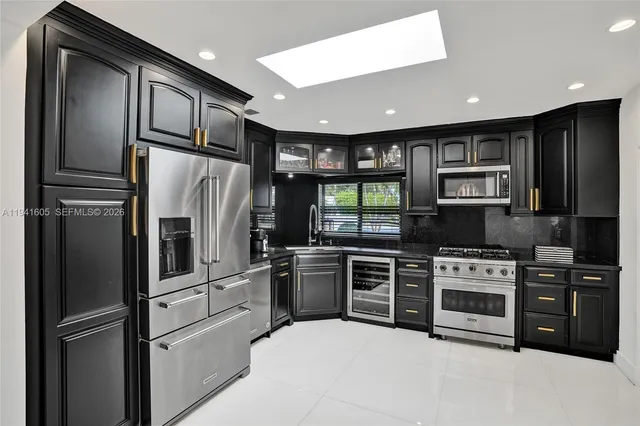 a living room with furniture a table and a large window