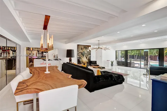 a living room with furniture and view of kitchen