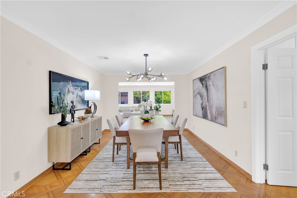2395 Cooley Place Pasadena, CA 91104 - Photo 11 of 46 a dining room with wooden floor a chandelier a wooden table and chairs