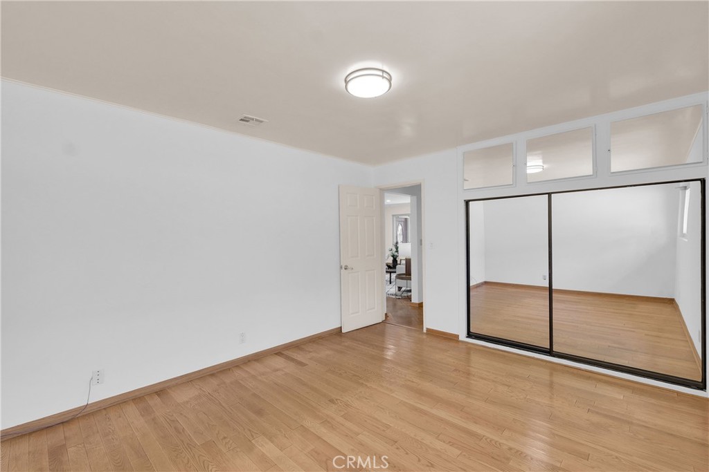 2395 Cooley Place Pasadena, CA 91104 - Photo 29 of 46 an empty room with wooden floor and sliding glass door