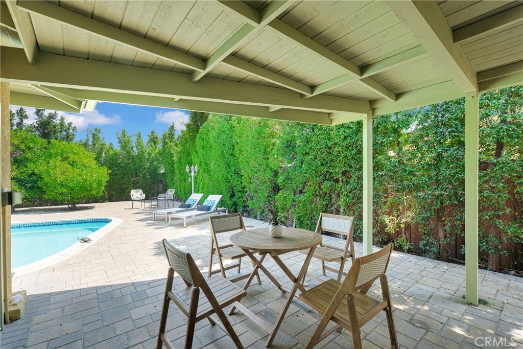 2395 Cooley Place Pasadena, CA 91104 - Photo 30 of 46 a view of a patio with a table chairs and a backyard