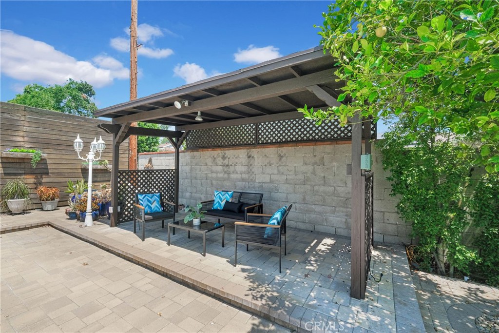 2395 Cooley Place Pasadena, CA 91104 - Photo 33 of 46 a view of a patio with table and chairs potted plants with wooden floor