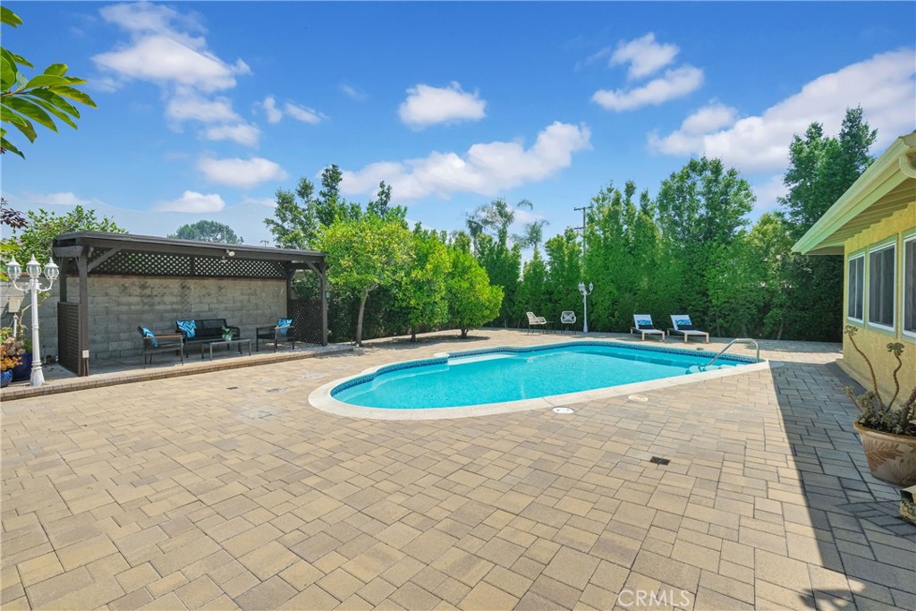 2395 Cooley Place Pasadena, CA 91104 - Photo 35 of 46 a view of a swimming pool with an outdoor space and seating area