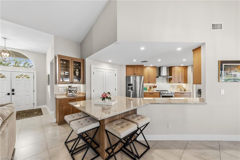 4724 Riverside Drive Estero, FL 33928 - Photo 8 of 44 a living room with furniture and kitchen view
