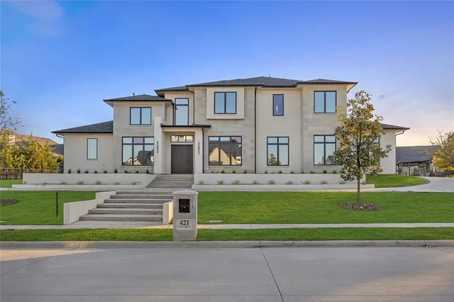 a front view of a house with a yard table and chairs