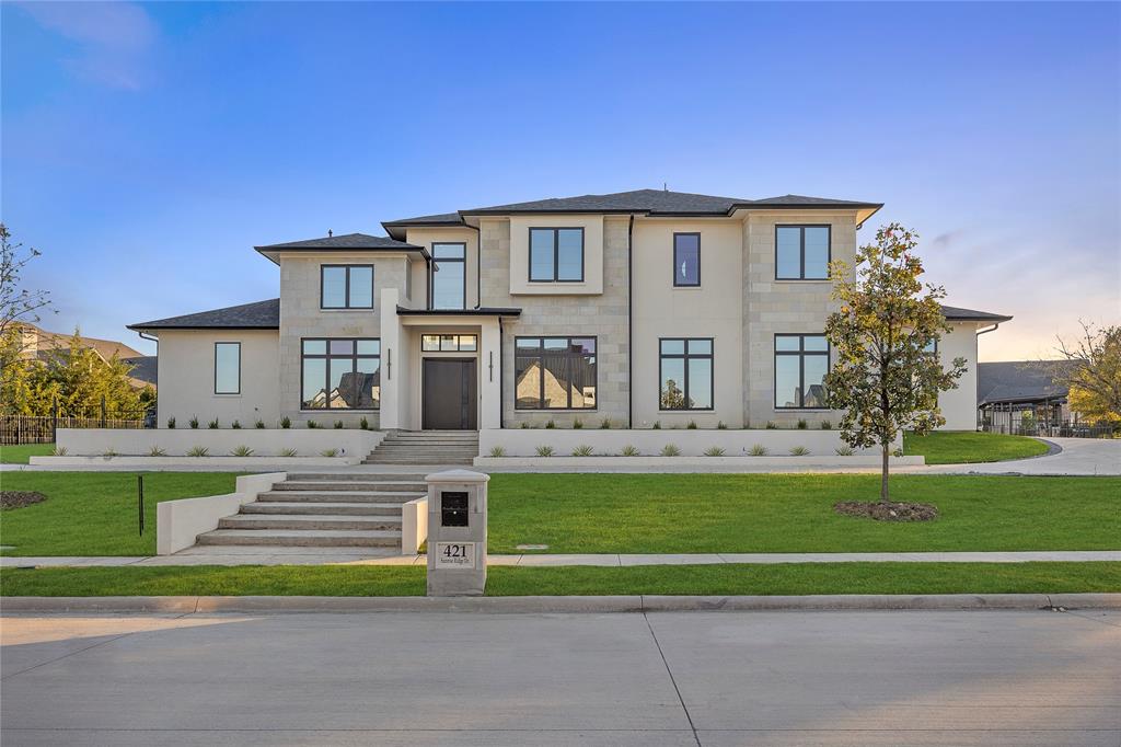 a front view of a house with a yard table and chairs