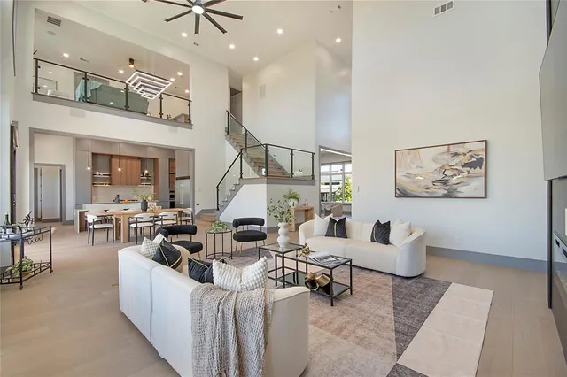 a dining room with furniture and a floor to ceiling window