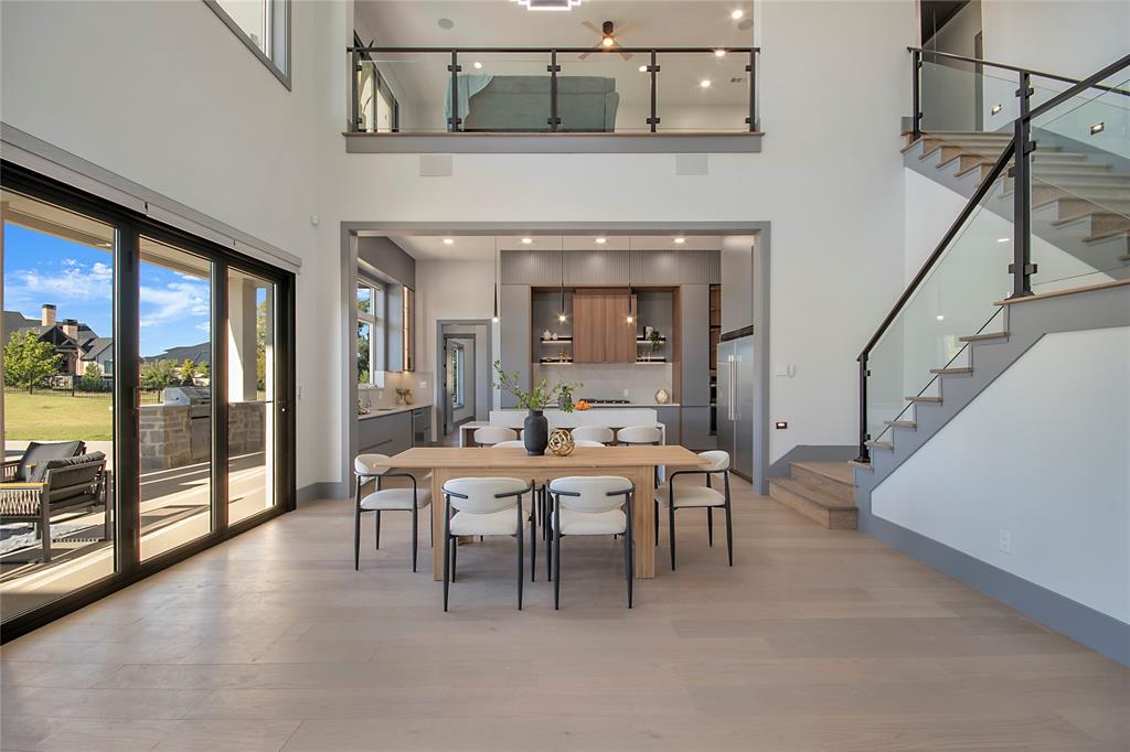 421 Sunrise Ridge Drive Heath, TX 75032 - Photo 12 of 39 a dining room with furniture and a floor to ceiling window