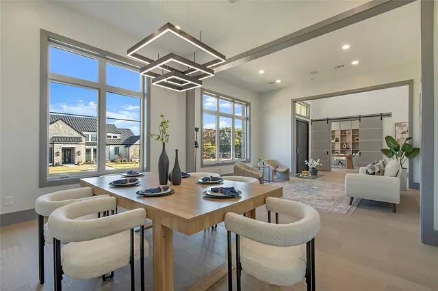 a dining room with furniture and a chandelier