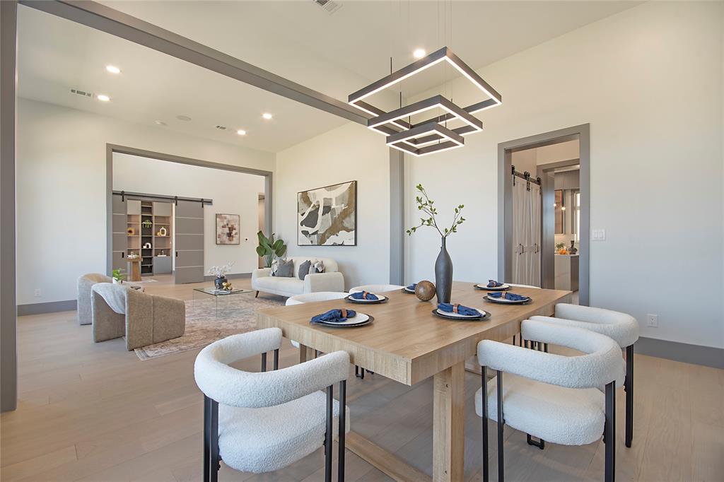 421 Sunrise Ridge Drive Heath, TX 75032 - Photo 21 of 39 a dining room with furniture and a chandelier