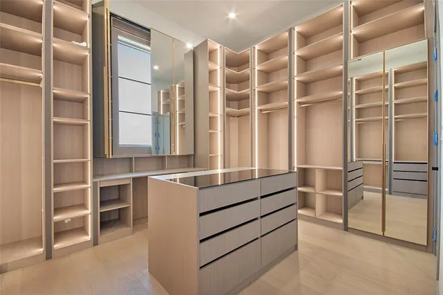 a spacious bathroom with a double vanity sink a mirror and a bathtub