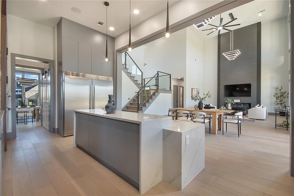 421 Sunrise Ridge Drive Heath, TX 75032 - Photo 8 of 39 a very nice looking living room with a large window and stainless steel appliances