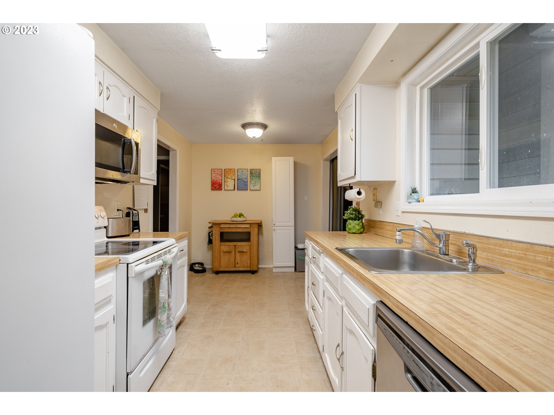 1857 Southwest 5th Street Gresham, OR 97080 - Photo 11 of 40 a kitchen with a sink stove and refrigerator