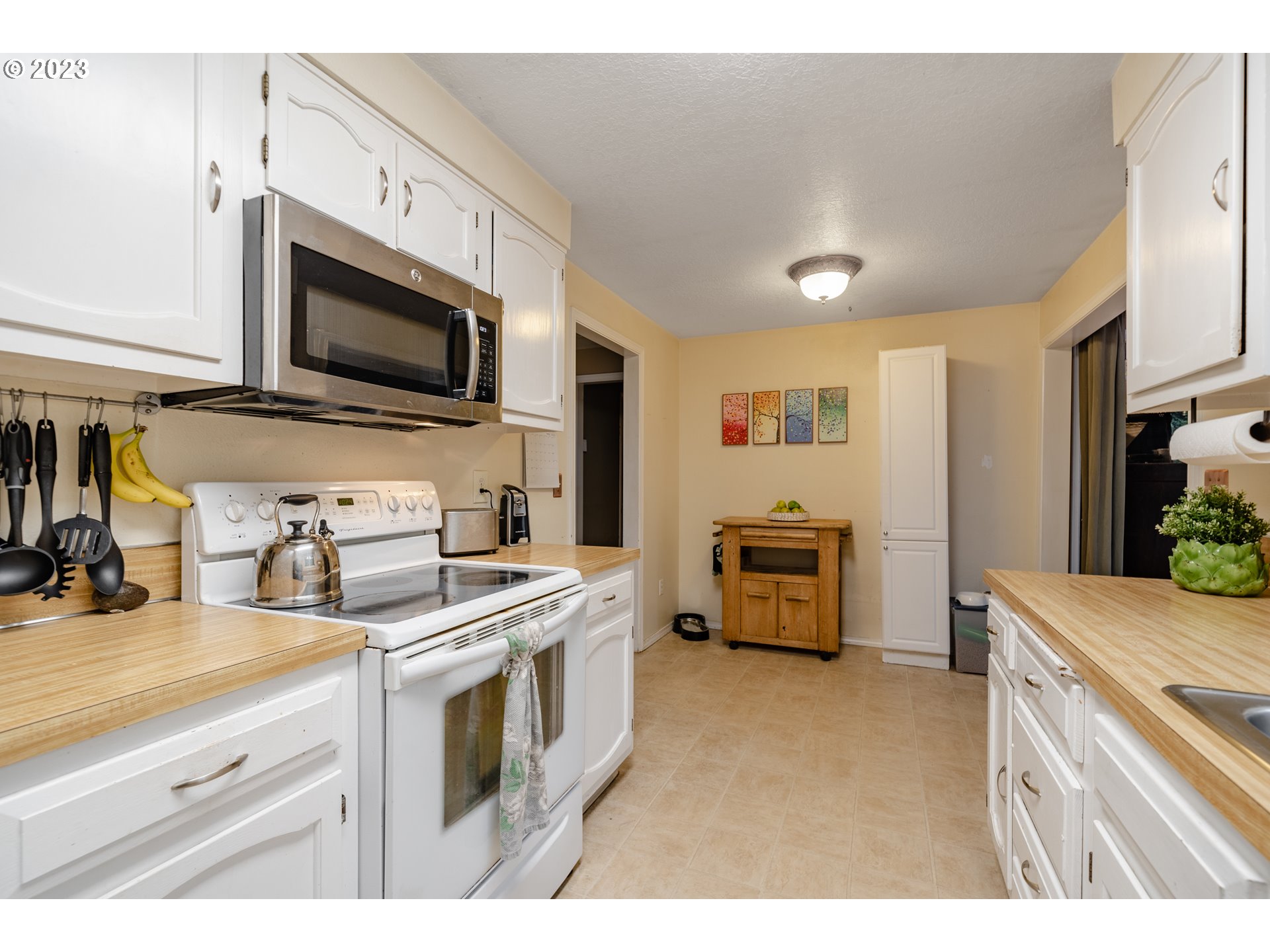 1857 Southwest 5th Street Gresham, OR 97080 - Photo 12 of 40 a kitchen with a stove and a microwave
