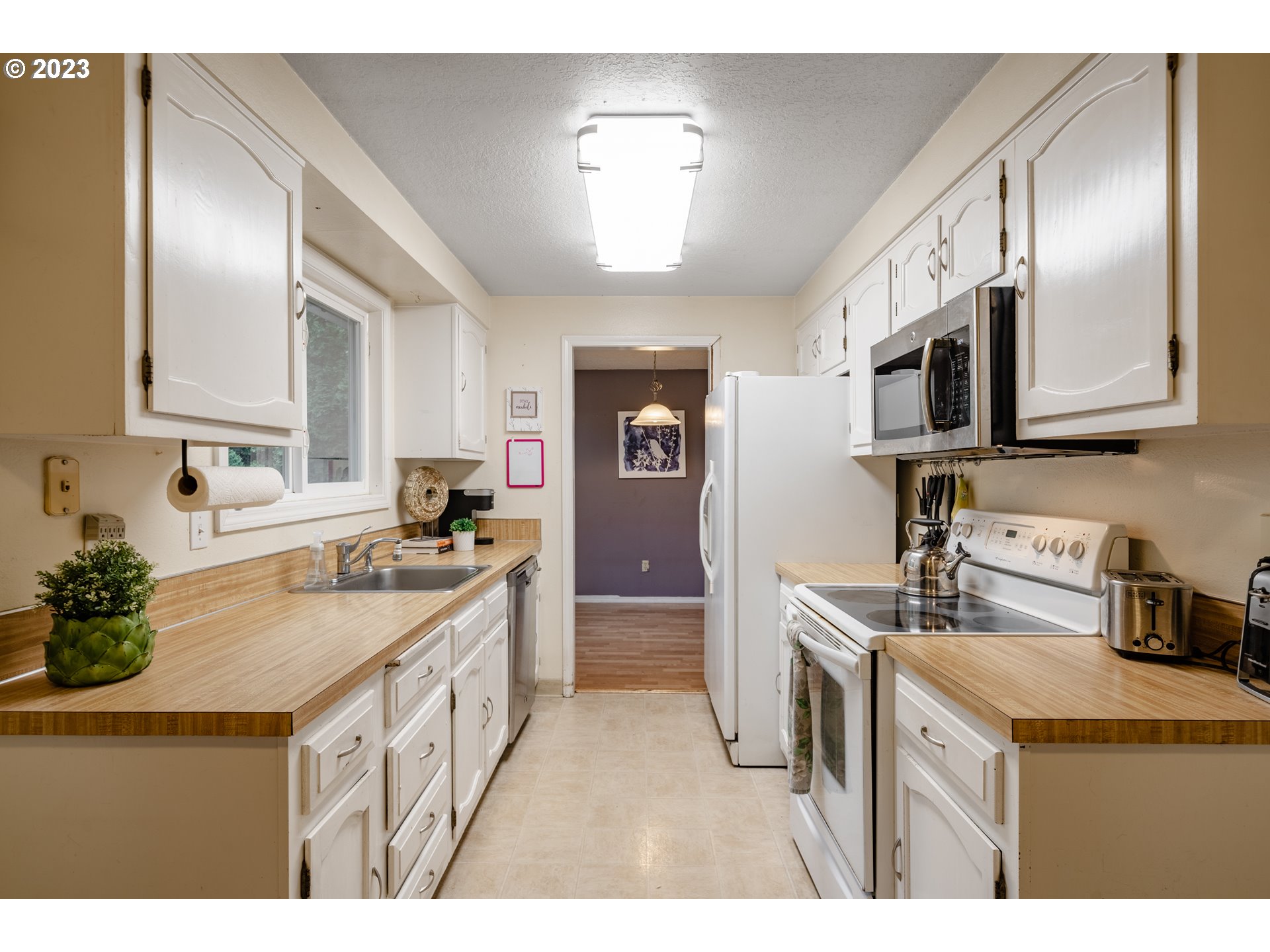 1857 Southwest 5th Street Gresham, OR 97080 - Photo 13 of 40 a kitchen with stainless steel appliances granite countertop a sink stove and refrigerator