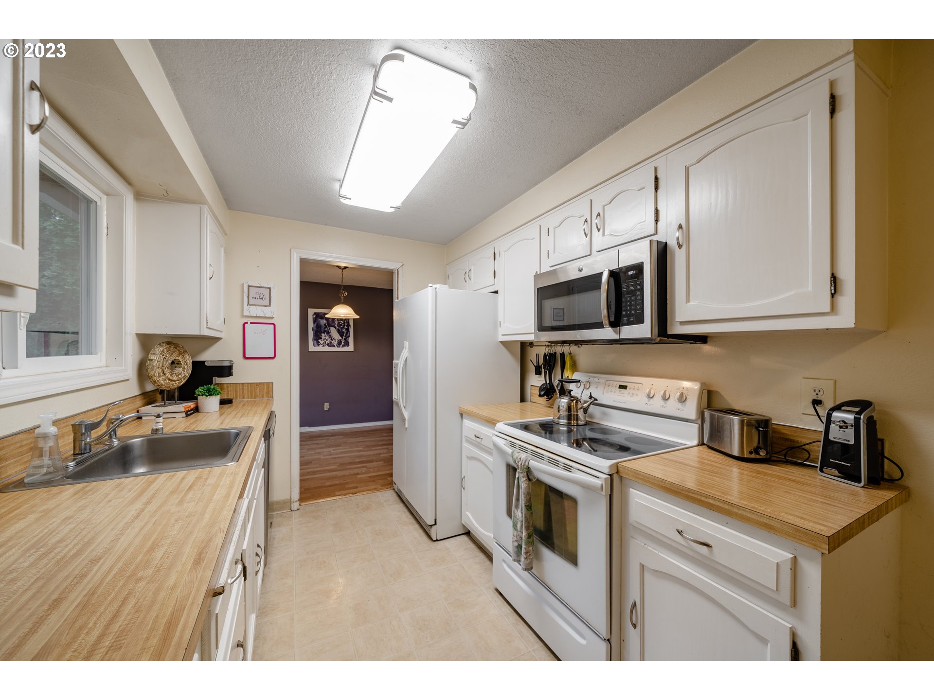 1857 Southwest 5th Street Gresham, OR 97080 - Photo 14 of 40 a kitchen with a stove a sink and a microwave