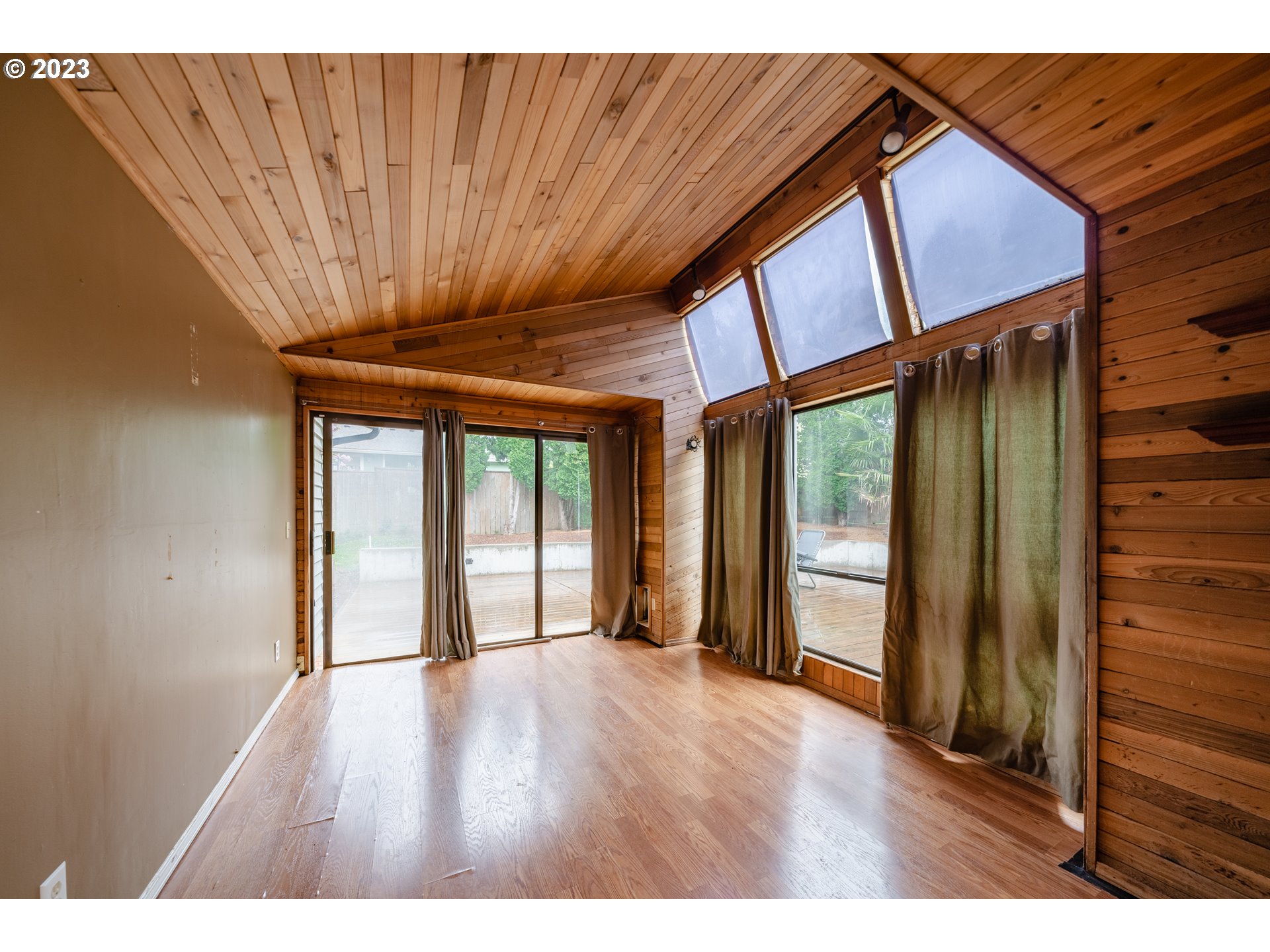 1857 Southwest 5th Street Gresham, OR 97080 - Photo 16 of 40 a view of an empty room with wooden floor and a window