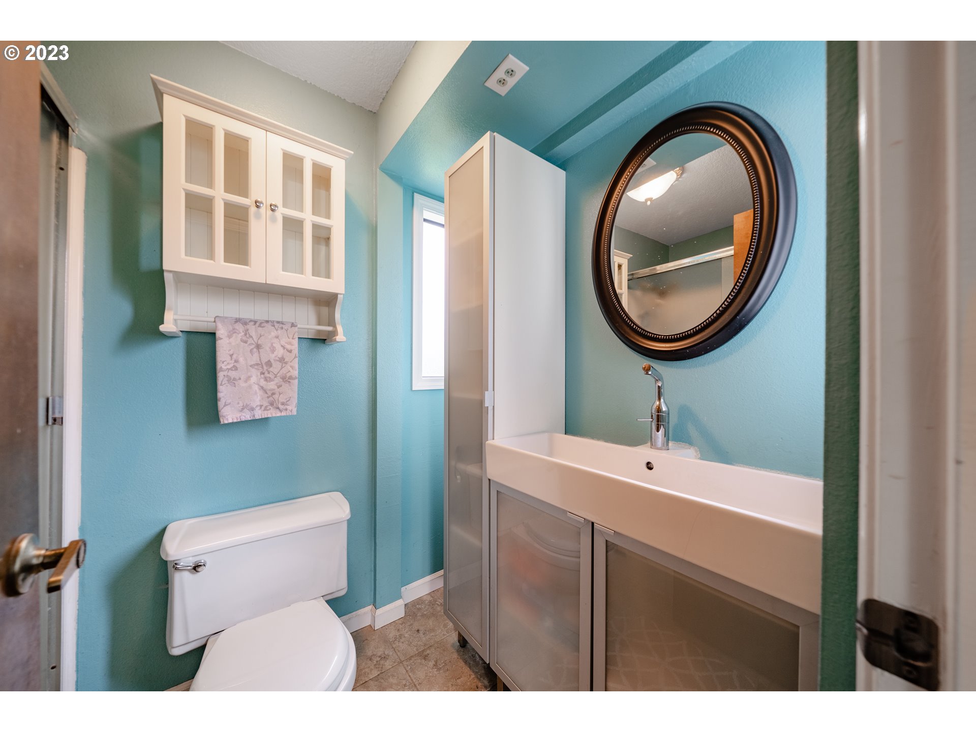 1857 Southwest 5th Street Gresham, OR 97080 - Photo 21 of 40 a bathroom with a toilet a sink and a mirror