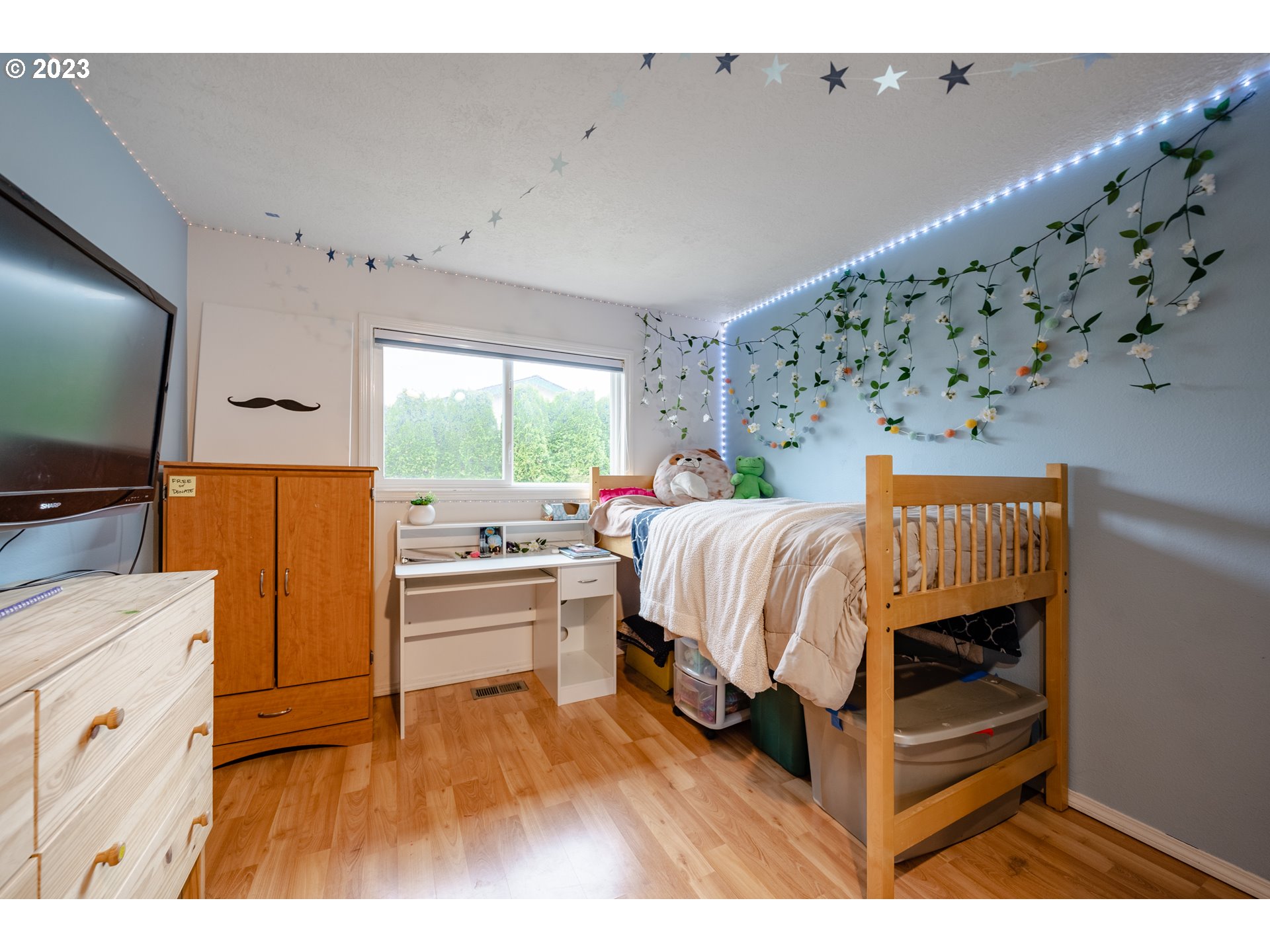 1857 Southwest 5th Street Gresham, OR 97080 - Photo 26 of 40 a bedroom with a bed and a flat tv screen on dresser