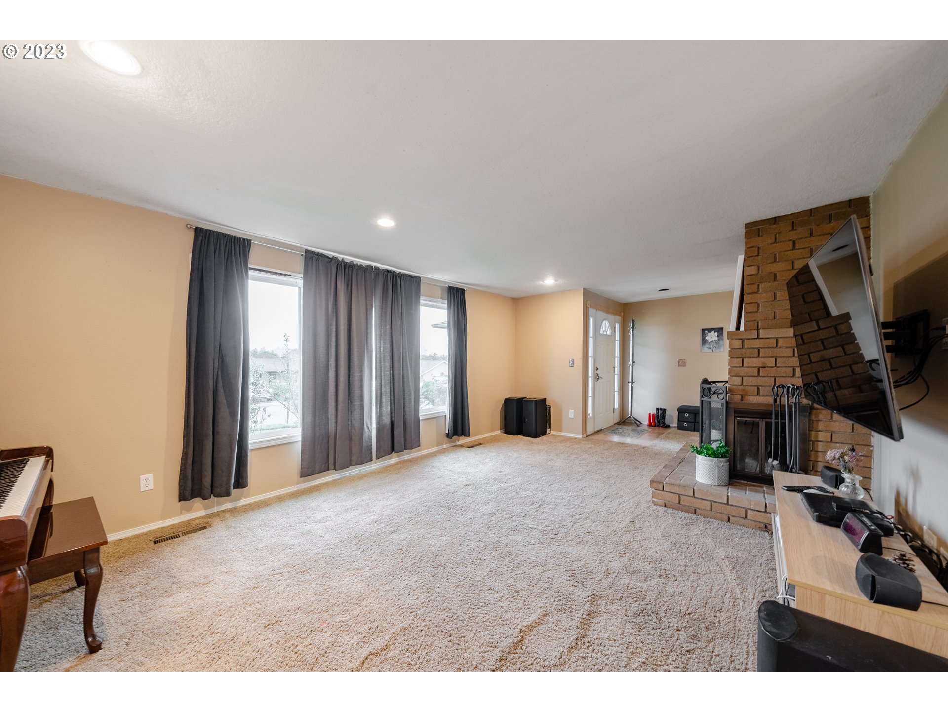1857 Southwest 5th Street Gresham, OR 97080 - Photo 9 of 40 a view of a livingroom with furniture and a flat screen tv