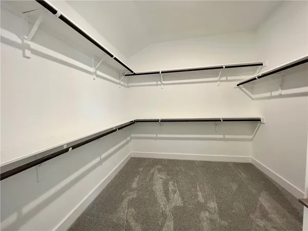 a spacious bathroom with a double vanity sink and a mirror