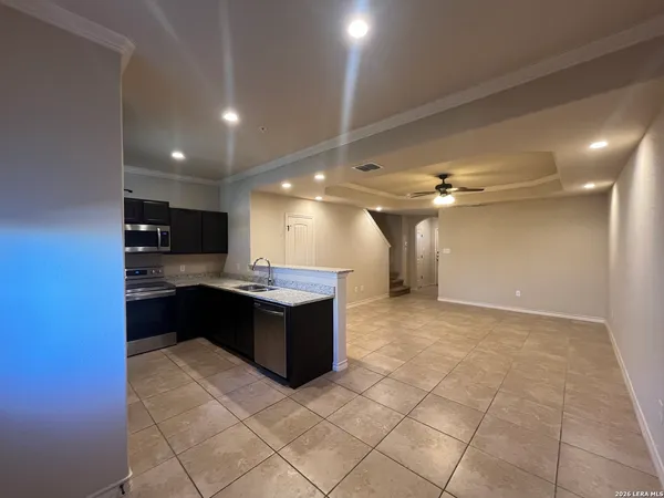 a kitchen with stainless steel appliances granite countertop a refrigerator and a stove top oven