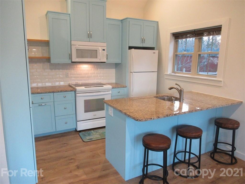 3487 Walker Road, Unit B Maiden, NC 28650 - Photo 8 of 22 a kitchen with stainless steel appliances granite countertop a stove a sink and a refrigerator