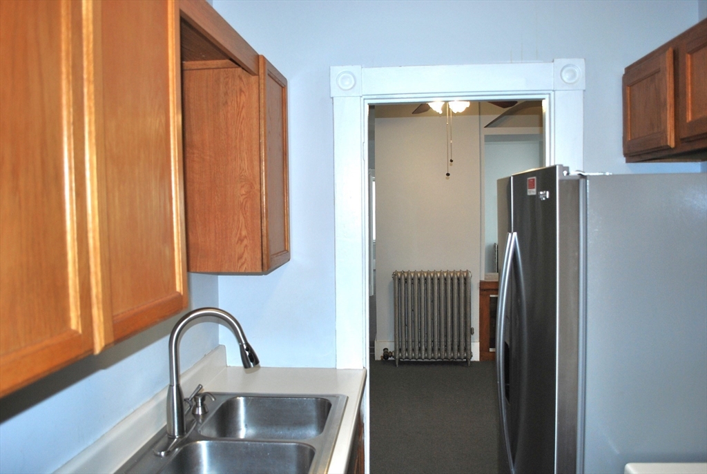 272 Mt Pleasant Street, Unit 2 New Bedford, MA 02746 - Photo 11 of 13 a bathroom with a sink and a mirror