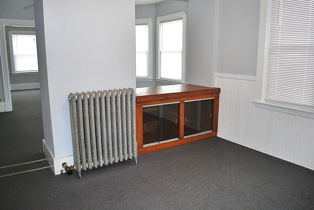 272 Mt Pleasant Street, Unit 2 New Bedford, MA 02746 - Photo 7 of 13 an empty room with windows