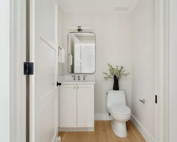 a white toilet sitting next to a bathroom sink