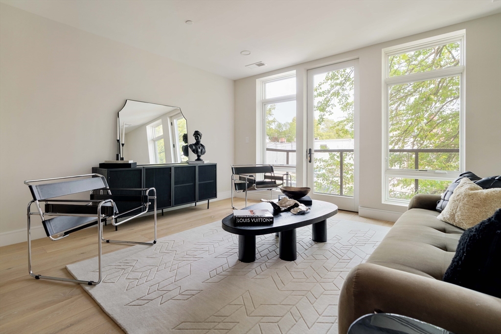 20 Kinmonth Road, Unit 203 Newton, MA 02468 - Photo 9 of 18 a living room with furniture and a large window
