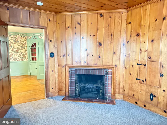a bedroom with a fireplace and a window