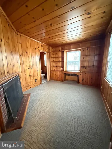 a view of a livingroom with furniture and a window