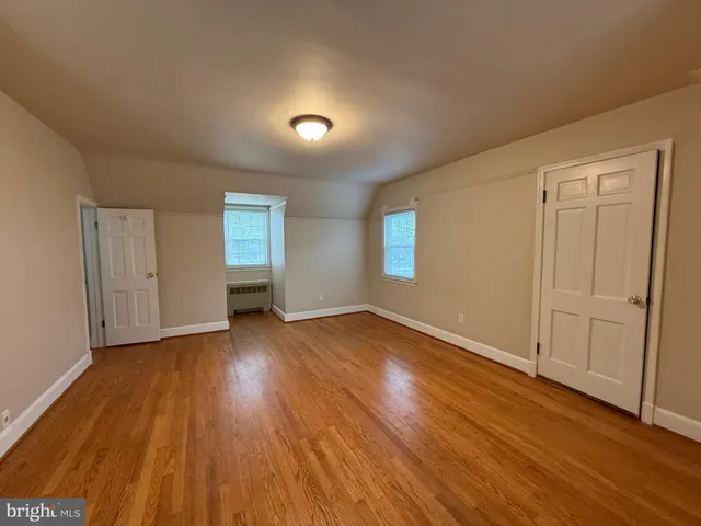 a view of an empty room and wooden floor