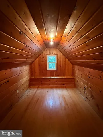 a view of a room with wooden walls