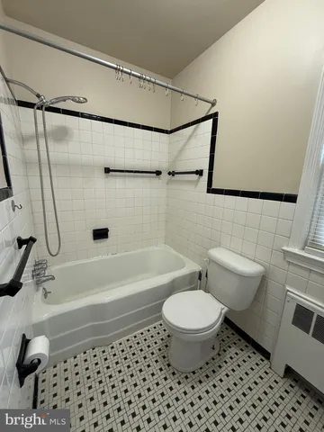 a bathroom with a toilet a sink and a shower