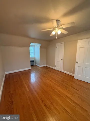 a view of an empty room and wooden floor