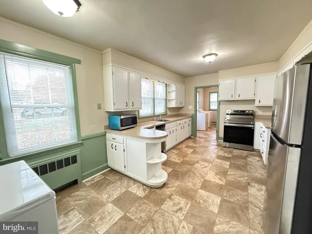 a kitchen with a stove a sink and a refrigerator
