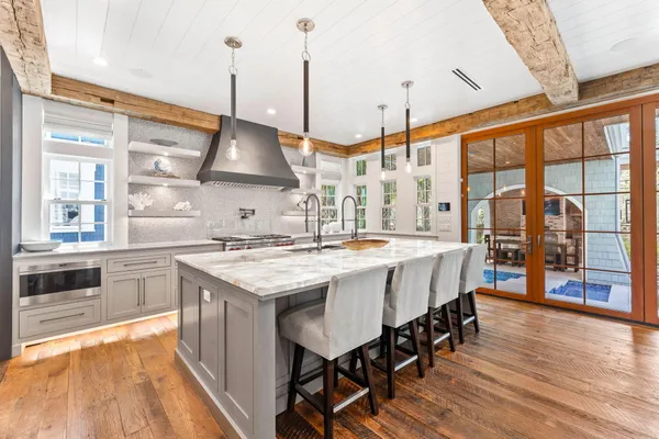 a stove top oven sitting inside of a kitchen